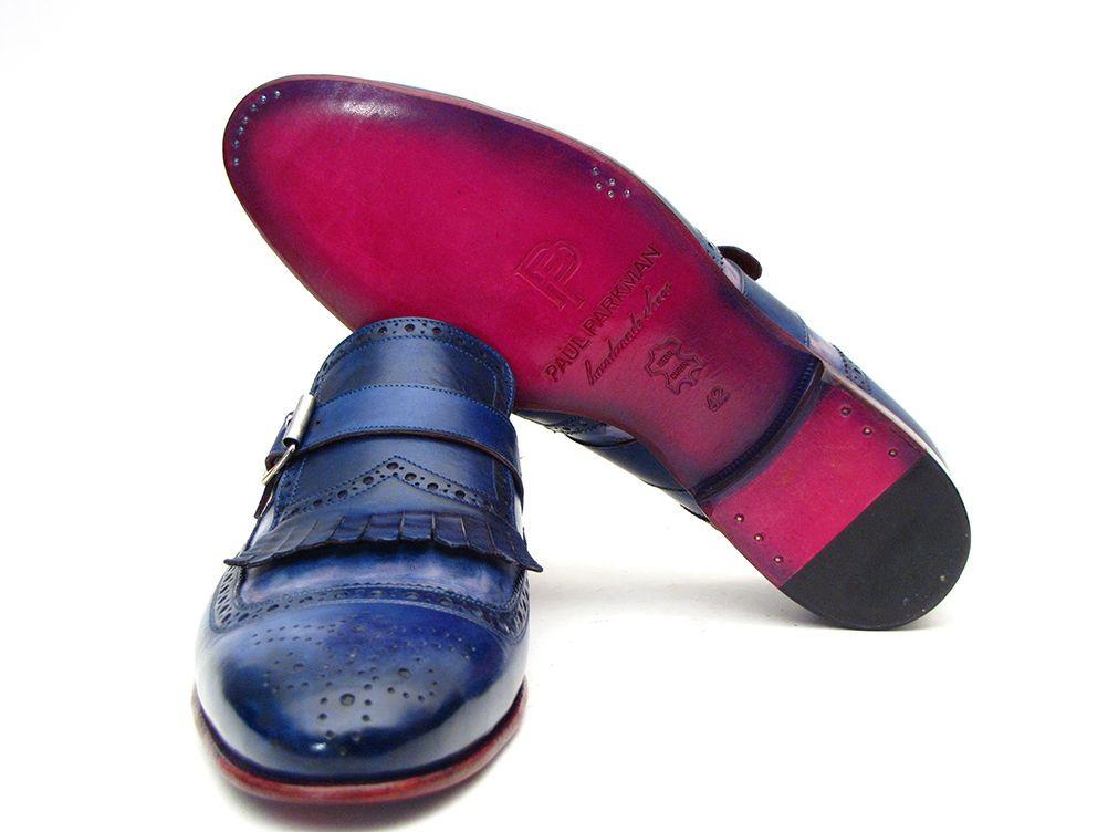 Introducing the Paul Parkman Kiltie Monkstrap Shoes, model 12BL78. This exquisite pair showcases handpainted dual-tone blue calfskin leather adorned with brogue detailing, buckles, and fringe accents. Crafted to order for those who appreciate timeless elegance and craftsmanship, these shoes embody the renowned quality of Paul Parkman.