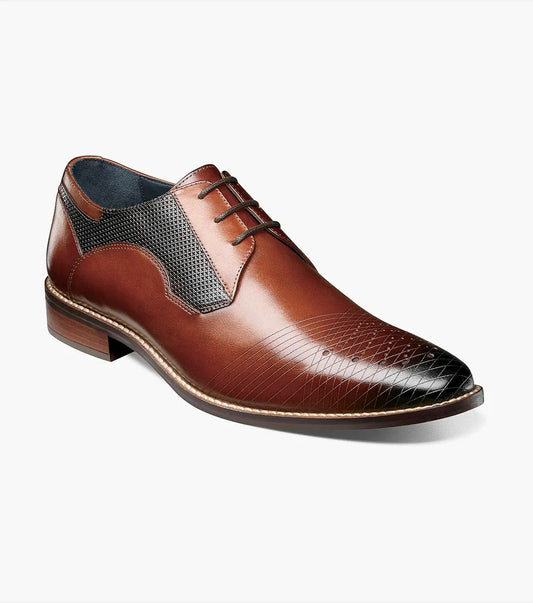 A Stacy Adams - JOVIAN Plain Toe Laser Oxford in cognac, featuring brown leather with black accents and textured patterns on the toe and side, crafted from laser-treated leather, is showcased against a plain white background.