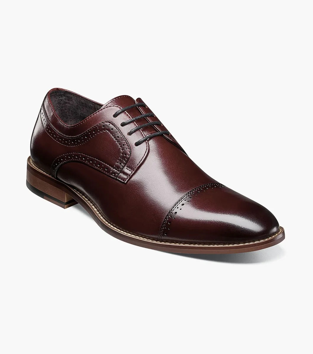 The Stacy Adams DICKINSON Cap Toe Oxford in Burgundy, style number 25066-601, is a classic leather dress shoe from STACY ADAMS. It features laces and decorative stitching and is enhanced with memory foam for ultimate comfort, set against a white background.