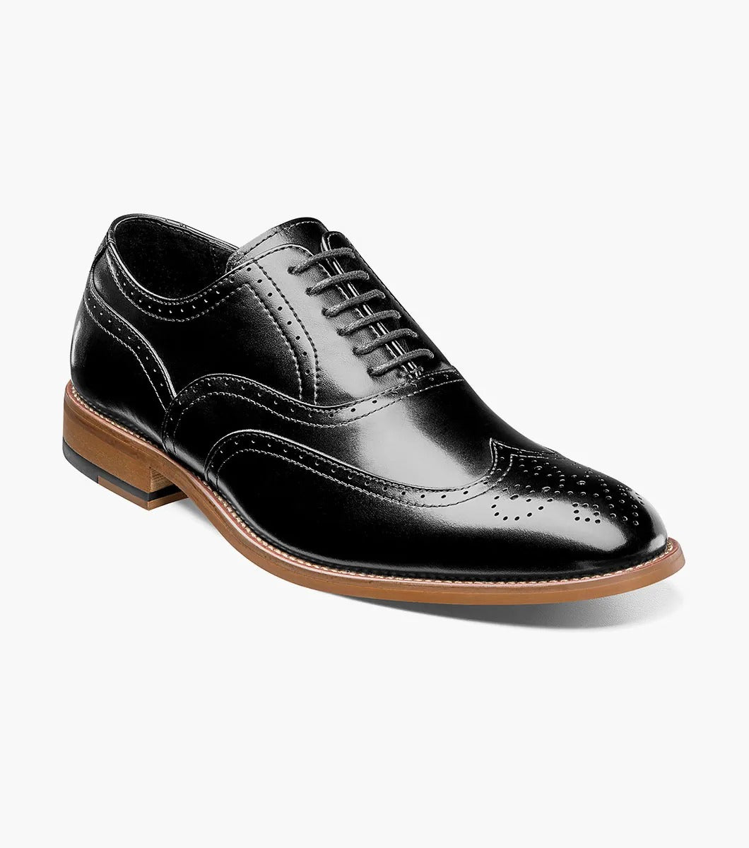 The Stacy Adams DUNBAR Wingtip Oxford in black features decorative perforations, a tan sole, and a comfortable memory foam insole.