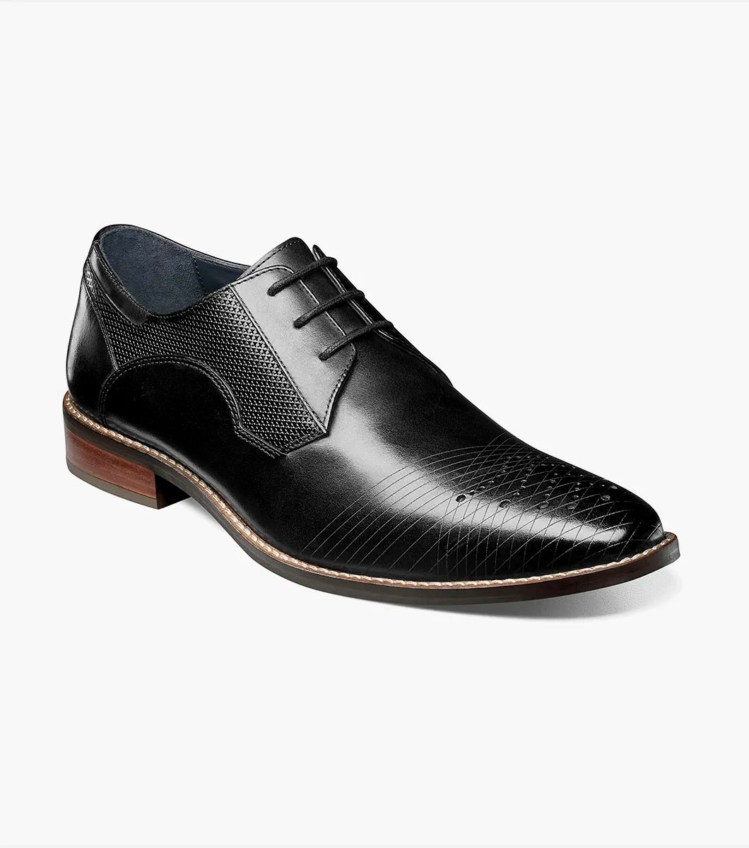 The Stacy Adams - JOVIAN Plain Toe Laser Oxford in black, product code 25504-001, is a premium dress shoe boasting a lace-up closure and distinctive brown detailing on the sole. Made from laser-treated leather for a sleek finish, it includes a Memory Foam insole to enhance comfort.