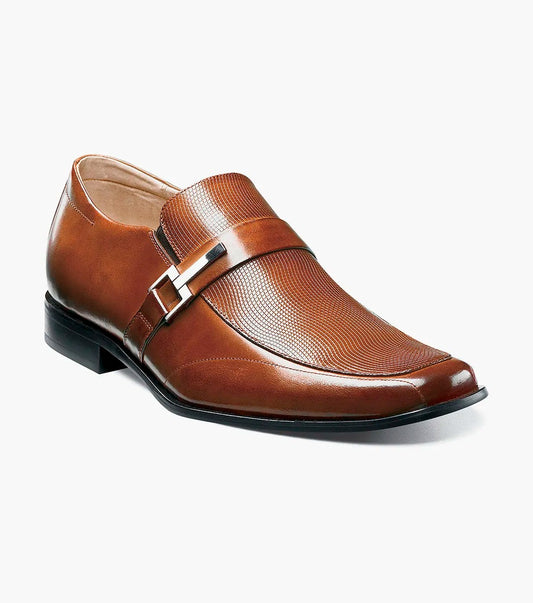 Step into elegance with the Stacy Adams - BEAU Moc Toe Loafer in Cognac, model number 24692-221. This sophisticated loafer spotlights a textured vamp, chic buckle detail, and a contrasting black sole. The premium leather upper elevates its design, while the cushioned insole provides all-day comfort for a stylish yet comfortable experience.