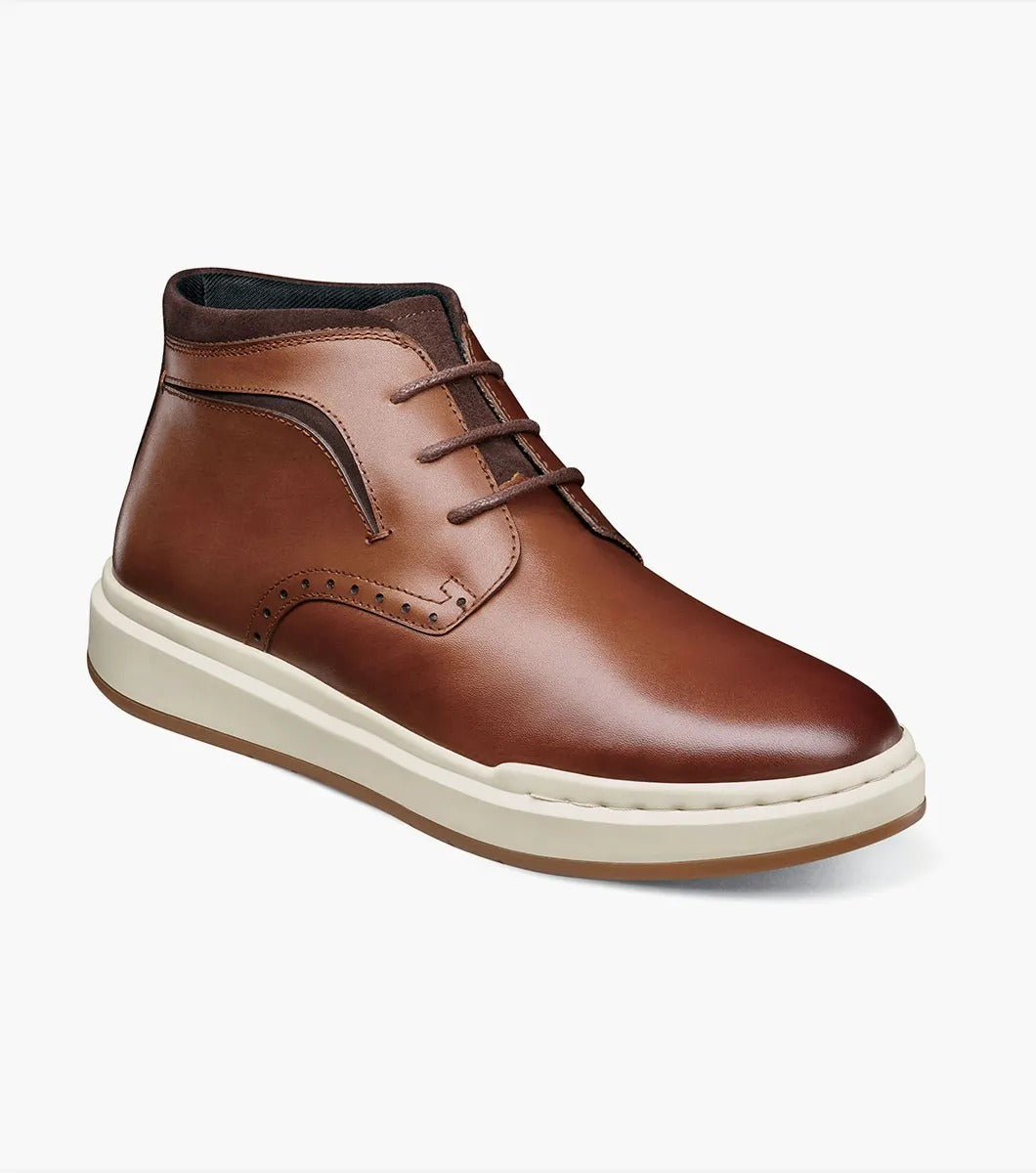 Stacy Adams' CORBIN Plain Toe Chukka Boot features a cognac smooth finish with decorative perforations, a comfortable insole, white sole, and brown laces displayed on a plain white background.