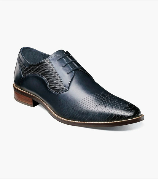 The JOVIAN Plain Toe Laser Oxford by Stacy Adams, in navy, showcases a sophisticated design with its dark blue leather finish and low wooden heel. The elegant look is enhanced by laser-treated textured patterns on the toe and sides.