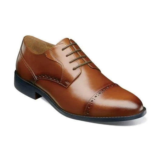 The Stacy Adams BARNETT Cap Toe Oxford in Scotch color, model 20196-232, is a classic brown burnished leather dress shoe with decorative stitching and laces. It features a low heel, smooth sole, and embodies the timeless elegance of a Cap Toe Oxford.