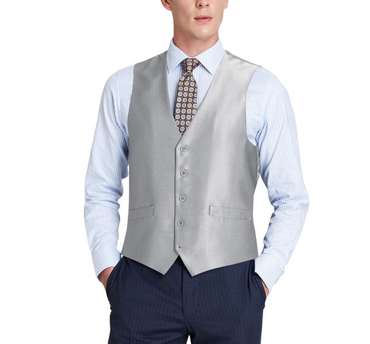 A man wearing an Alessandro Vitello by Renoir Grey Formal Regular Fit Suit Vest, Sharkskin Waistcoat 207-2, styled in light gray, pairs it with dark pants. His striped shirt and patterned tie complete the sophisticated ensemble crafted from a blend of polyester viscose fabric. With his hands in his pockets, the look exudes elegance and style.