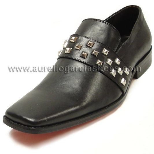 The FI-6563 Black Fiesso by Aurelio Garcia from the Fiesso brand is a slip-on leather shoe adorned with a band of silver studs across the top. It features a pointed toe and low heel, blending style and comfort with its cushioned insole.