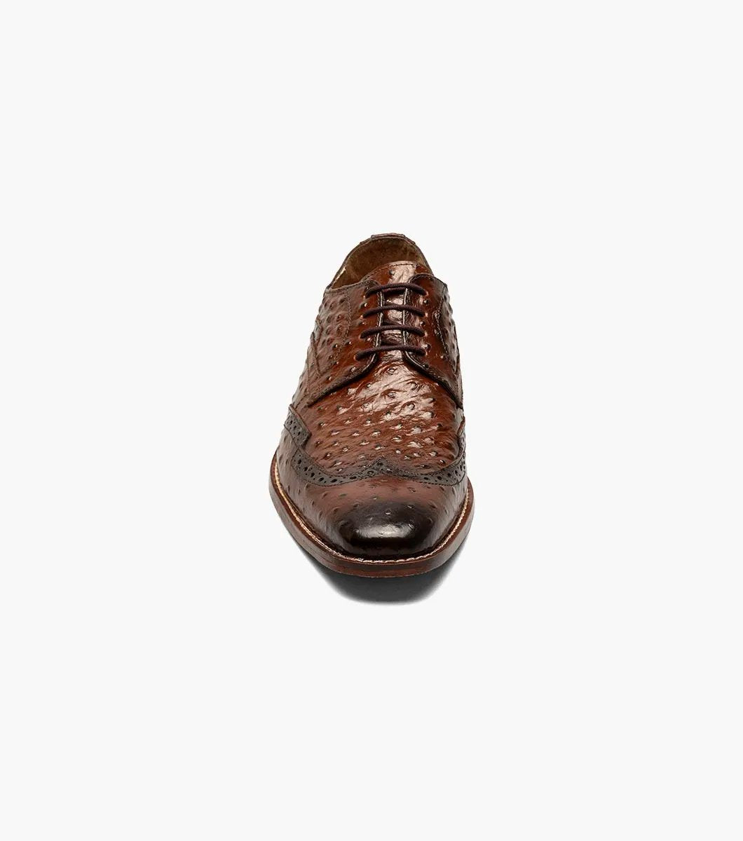 The Stacy Adams GENNARO Wingtip Oxford in Cognac, featuring elegant brogue detailing and a stylish wingtip design, is crafted from ostrich quill print leather and includes the RedZone removable footbed for superior comfort and support.