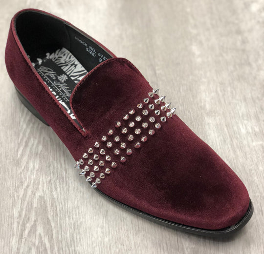 A Midnight Formal Shoe 6787 Burgundy/Silver from AFTER MIDNIGHT, featuring a row of silver spikes across the top, placed on a wooden floor.