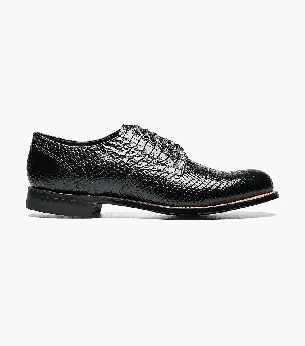 The Stacy Adams - MADISON Anaconda Plain Toe Oxford in black, designed by STACY ADAMS, is a glossy dress shoe with an anaconda print and laces, shown on a white background.