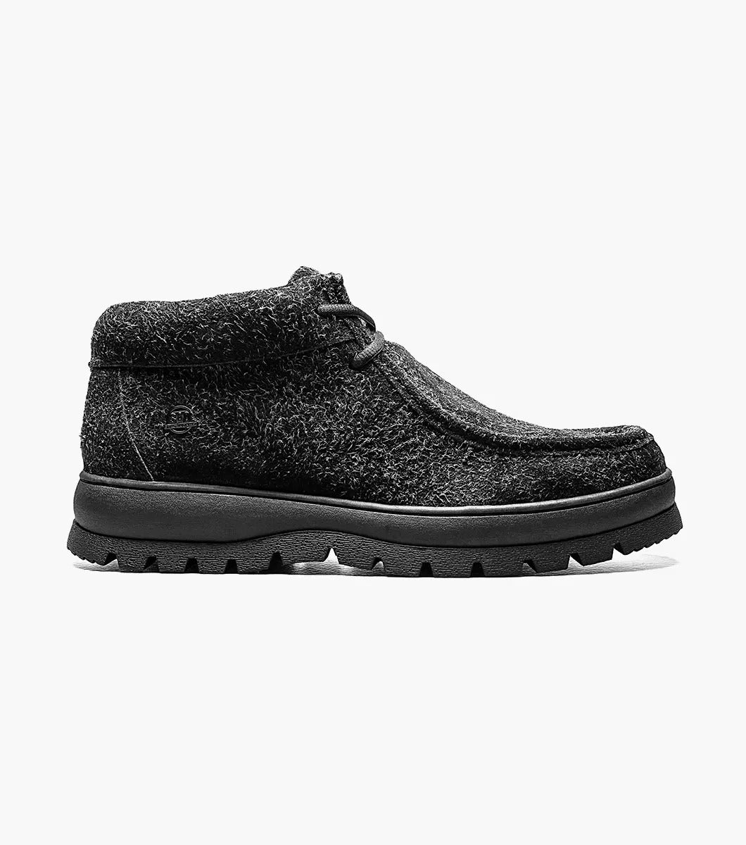 The Stacy Adams DUBLIN II Moc Toe Boot is a black multi ankle-high boot with a smooth, printed suede texture and a rugged chunk rubber sole with lace-up closure.