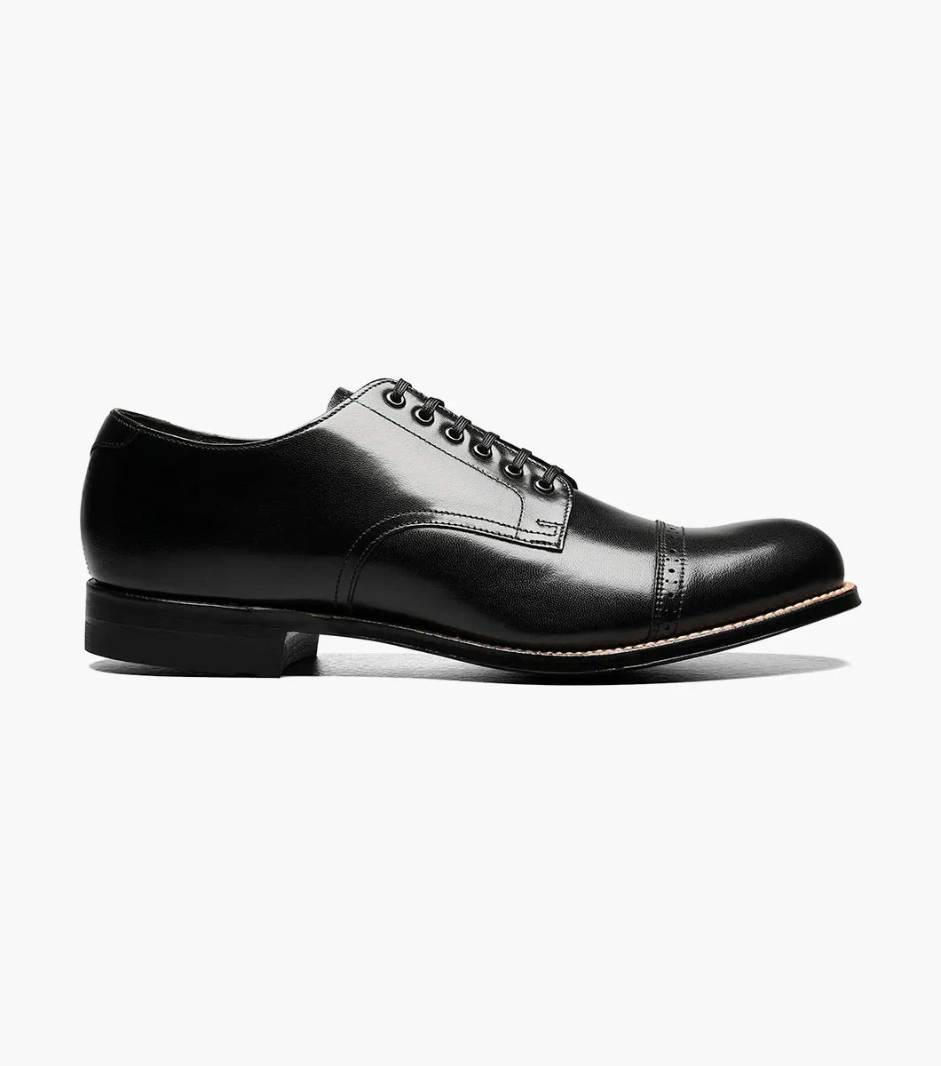 The Stacy Adams MADISON Cap Toe Oxford in black (product code: 00012-01) is a kidskin leather shoe with laces, presented against a pristine white background, and it boasts impeccable Goodyear welt construction for both durability and style.