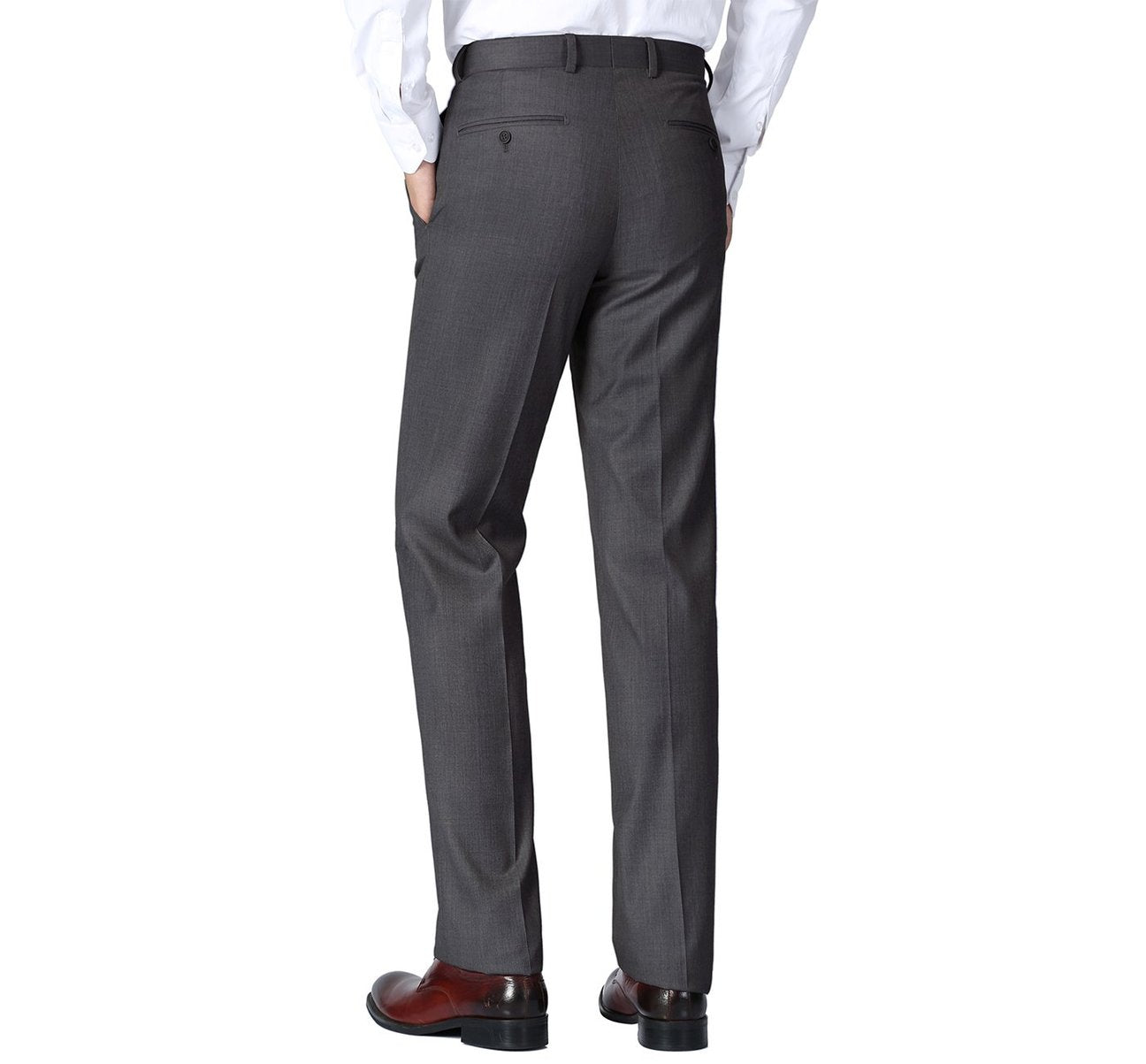 A person wearing Alessandro Vitello by Renoir charcoal classic fit flat front suit separate pants, a white shirt, and brown dress shoes stands against a plain white background.