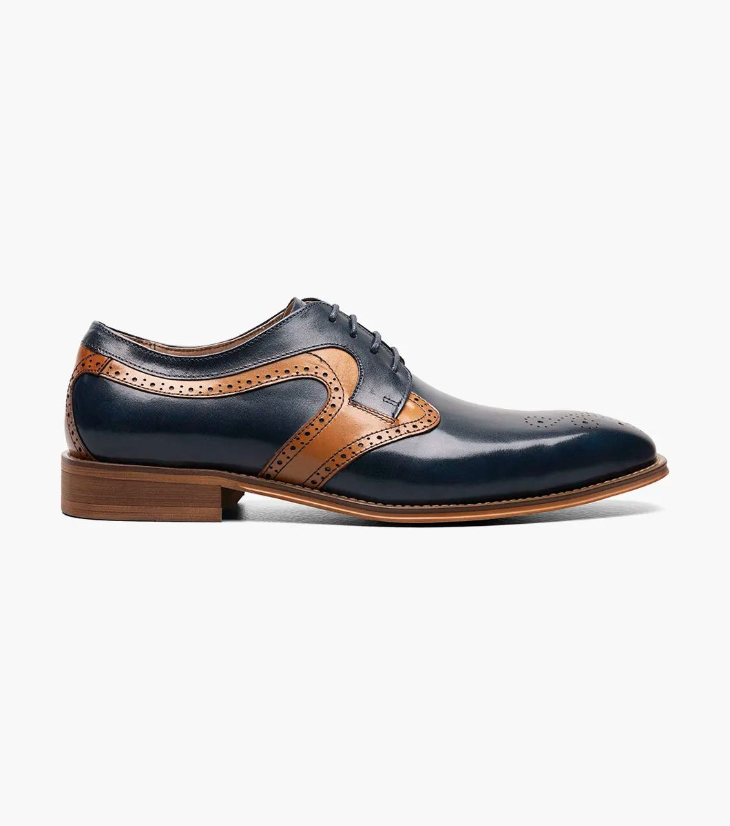 A side view of the Stacy Adams - PALMER Plain Toe Medallion Oxford showcases its navy and brown leather design, complete with decorative perforations and a wooden heel.