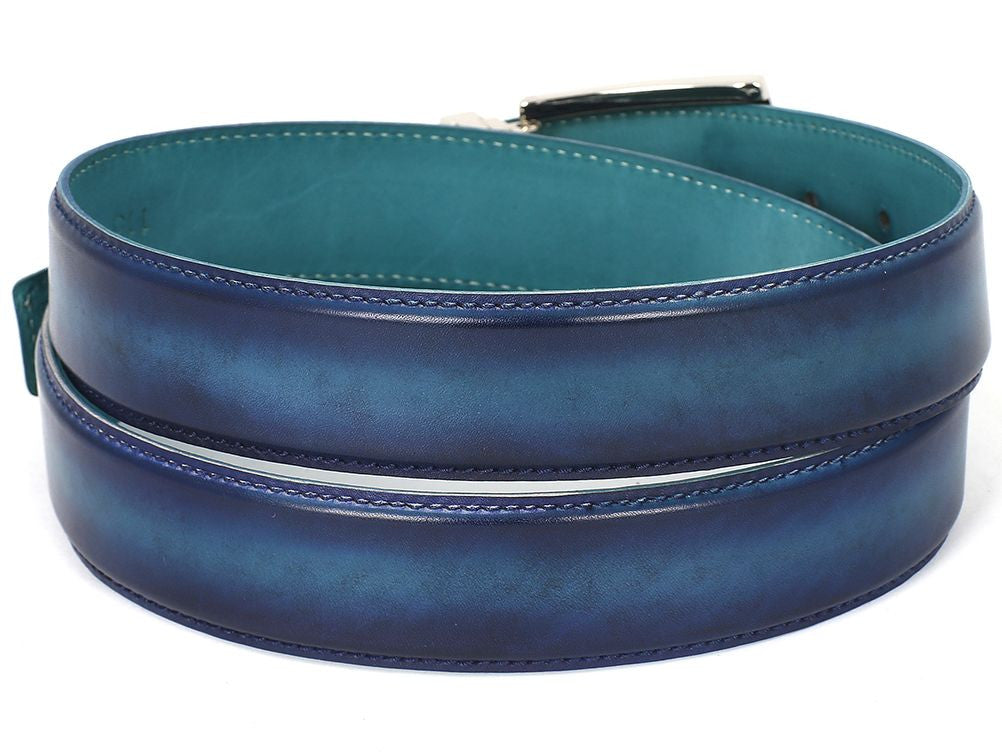 The Paul Parkman Leather Belt Dual Tone Blue & Turquoise (B01-BLU-TRQ) is a hand-painted accessory crafted from Italian calfskin leather. It features a distinctive blue hue with a silver buckle and embossed branding.