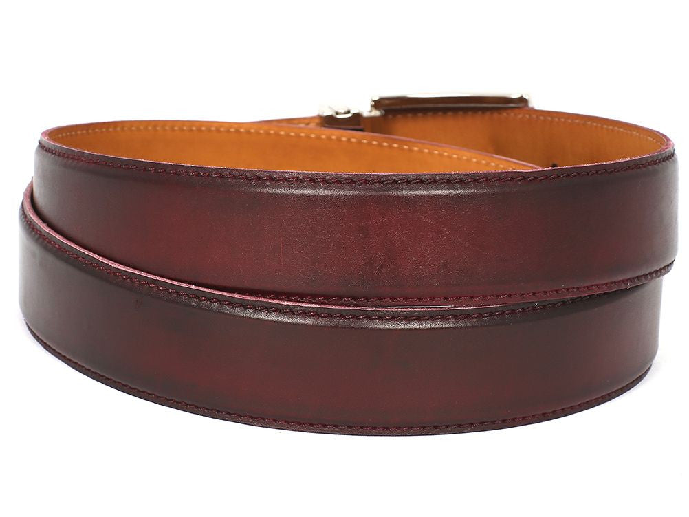 The Paul Parkman Leather Belt Hand-Painted Dark Bordeaux - B01-DARK-BRD, showcasing a brand name engraved on a silver buckle, exemplifies craftsmanship. Each piece is hand-painted to perfection and made-to-order for those who appreciate quality and style.