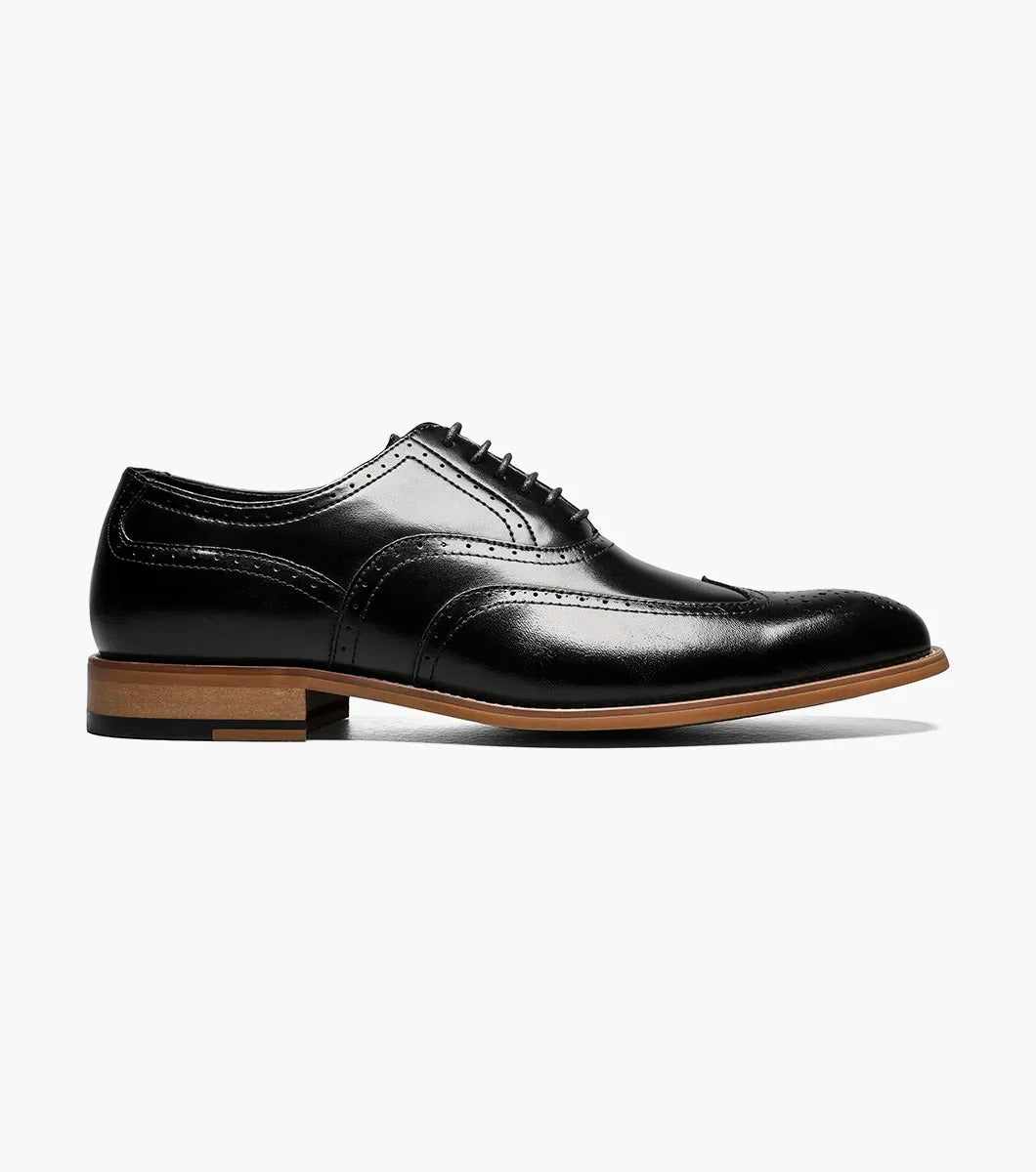 The Stacy Adams DUNBAR Wingtip Oxford in black features decorative perforations, a tan sole, and a comfortable memory foam insole.