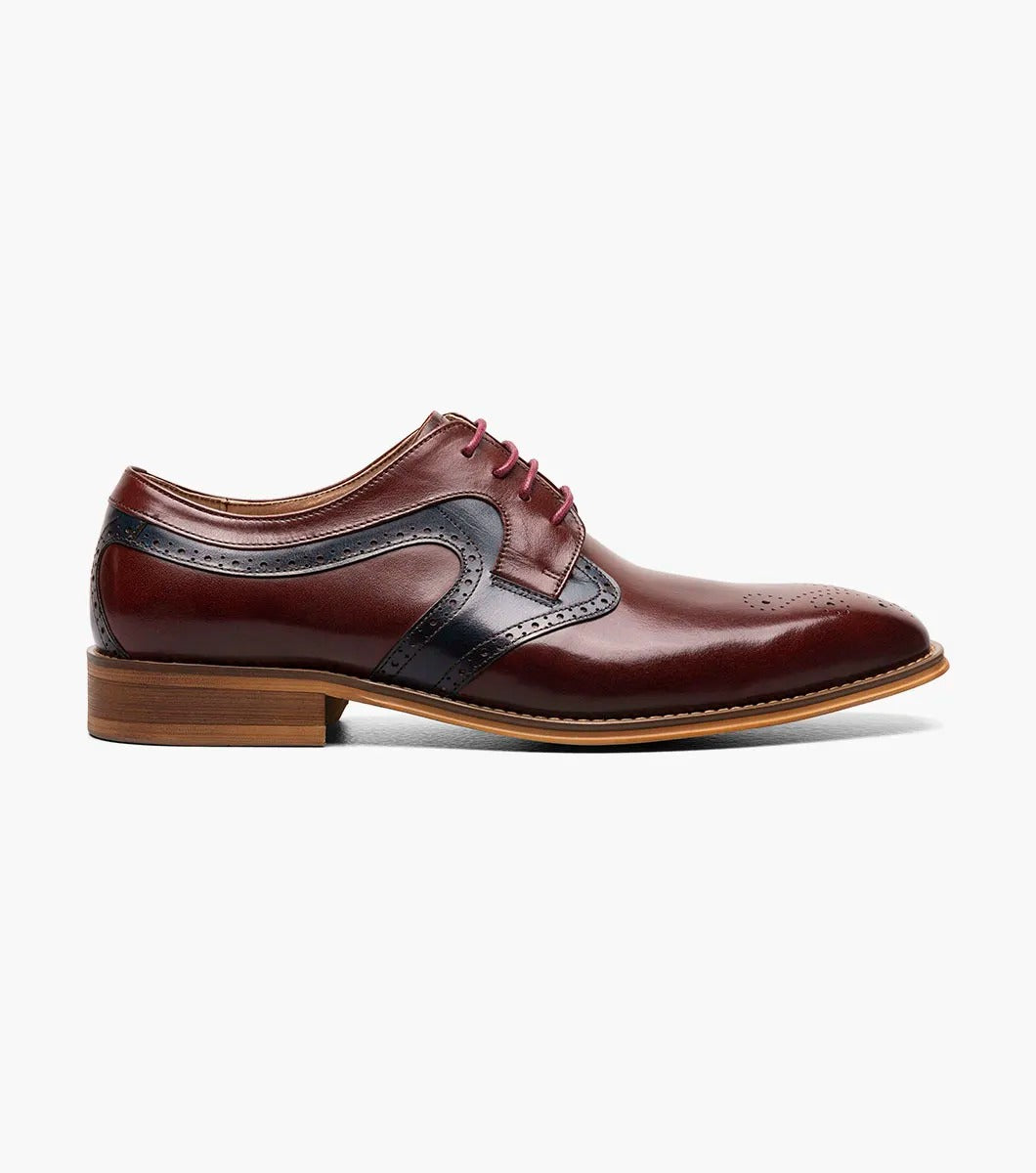 The STACY ADAMS Palmer Plain Toe Medallion Oxford in Burgundy Multi is an elegant men's dress shoe made from luxurious buffalo leather in burgundy and navy, featuring detailed perforations and a traditional wooden sole.