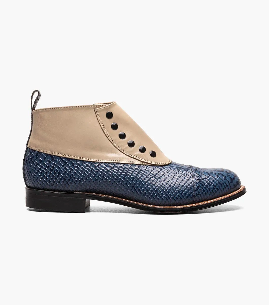 The MADISON Spectator Spat Cap Toe Demi Boot by STACY ADAMS boasts a chic design with a blue textured lower and smooth beige upper, made from kidskin leather, and adorned with five black button accents.