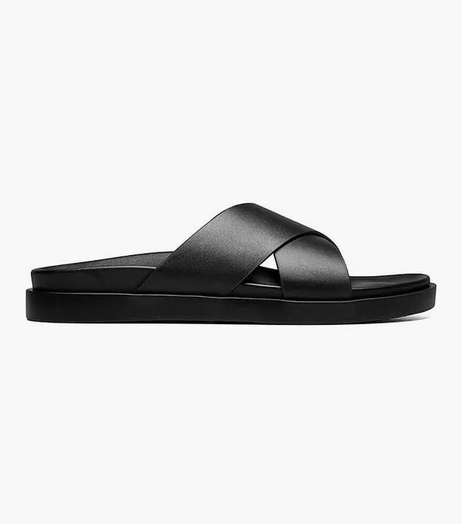 The STACY ADAMS - MONTEL Cross Strap Slide Sandal in Black (Product Number: 25469-001) showcases a sleek design featuring crisscross straps and a comfortable flat sole, complete with a cushioned insole for all-day support.