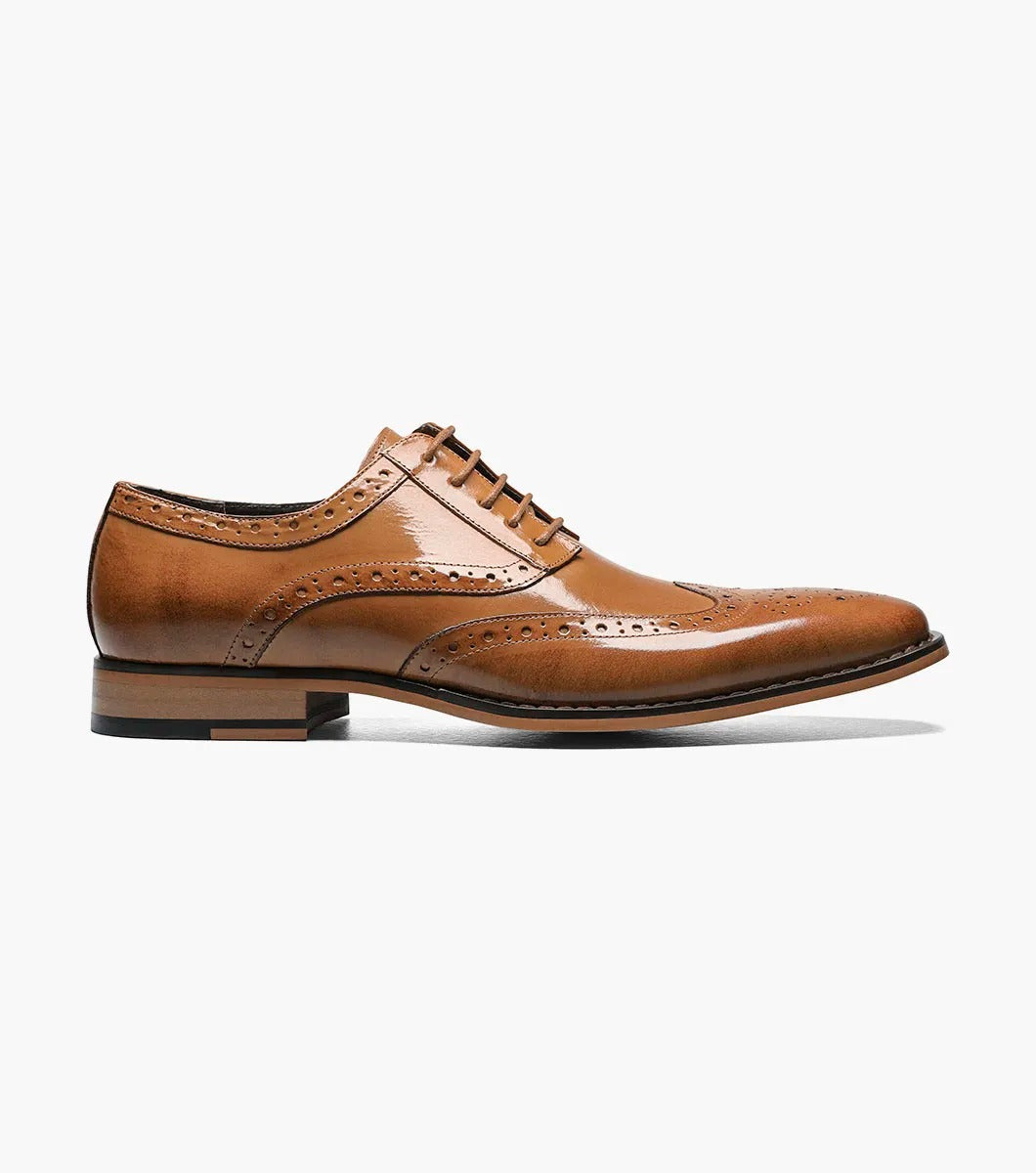 Stacy Adams' TINSLEY Wingtip Oxford in tan features brogue detailing with decorative perforations and laces, seen from the side on a white background.