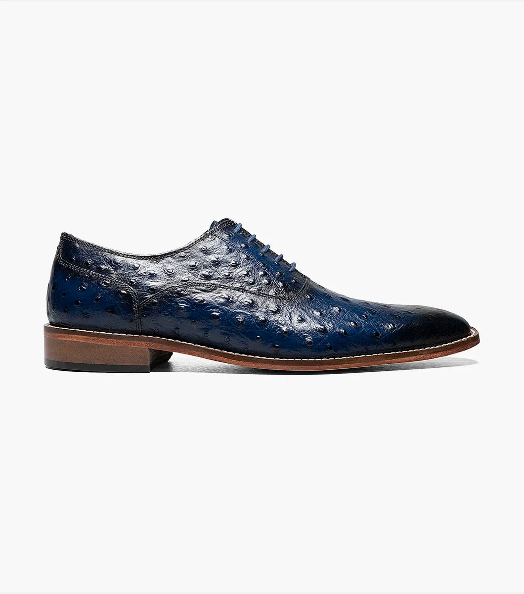 The STACY ADAMS - ROSELLI Leather Sole Plain Toe Oxford in blue, style number 25472-400, is meticulously crafted from burnished ostrich leather, featuring a rich texture that enhances its appeal. Complemented by a genuine leather sole, it offers both sophisticated style and Memory Foam comfort for all-day wear.