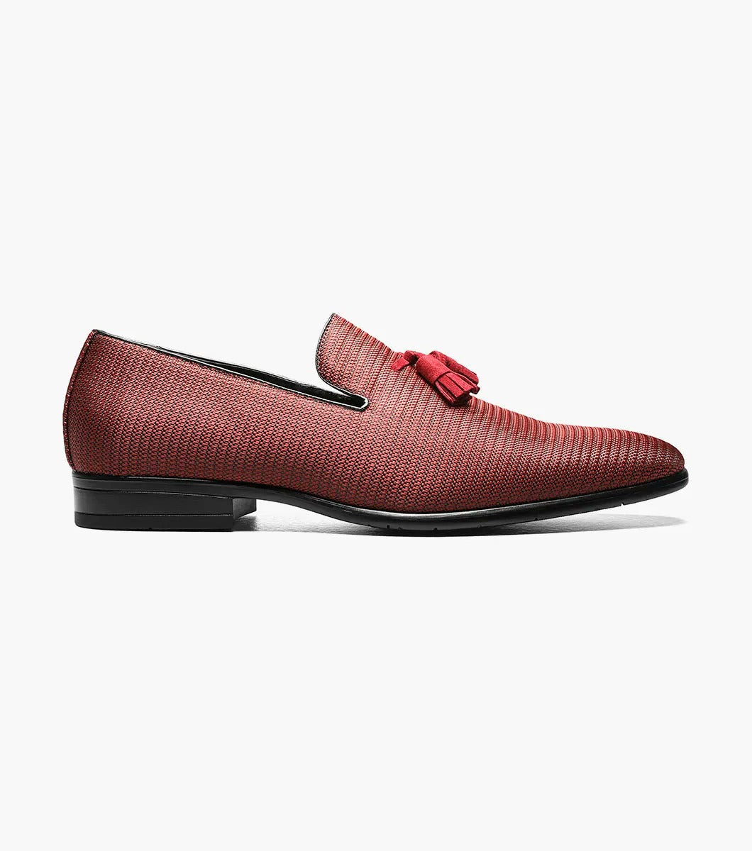 Introducing the Stacy Adams - Tazewell Plain Toe Tassel Slip On in Brick, characterized by its red textured design, black trim, and tassels on top. It features a fully cushioned footbed for ultimate comfort.