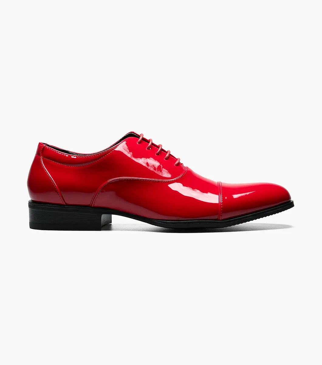 A solitary Stacy Adams GALA Cap Toe Oxford, product number 24998-600, made of shiny red patent leather with black soles and a closed lacing system featuring a memory foam insole, is displayed against a plain white background.