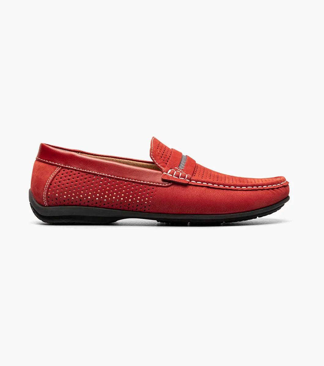 Introducing the Stacy Adams - CORBY Moc Toe Saddle Slip On in Red (25513-600). This shoe features a red leather loafer design with a perforated upper, complemented by black and red stripe detailing on top. It also boasts a durable rubber outsole, making it the ideal casual warm-weather shoe with its stylish appearance and comfortable fit from STACY ADAMS.