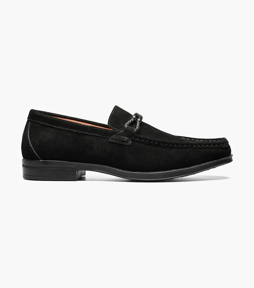 The Stacy Adams NEVILLE Moc Toe Bit Slip On in black suede showcases a metal chain detail on top, accompanied by a slightly elevated heel and stitched accents. Its cushioned insole provides comfort for all-day wear.