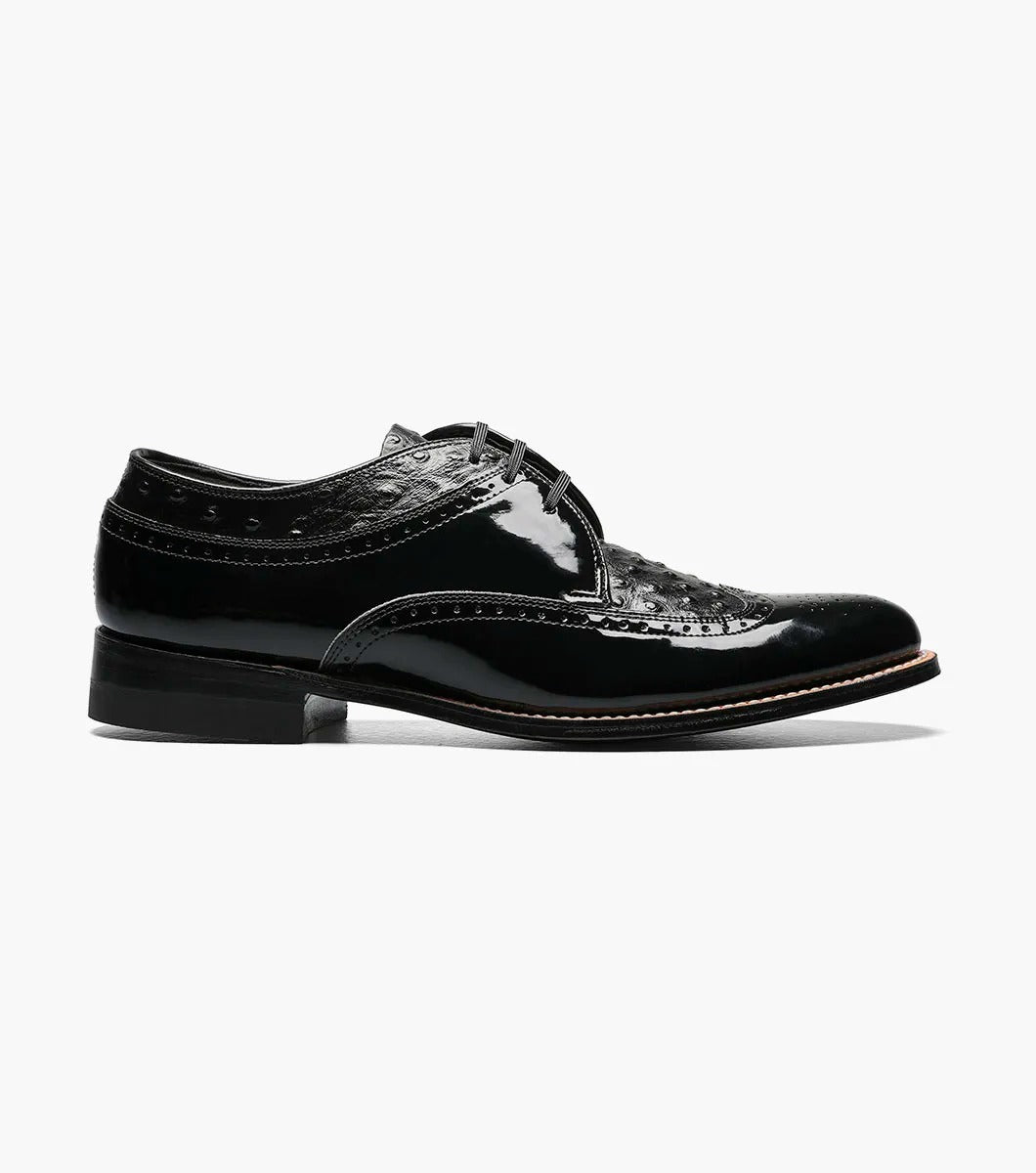 The Stacy Adams - DAYTON Ostrich Wingtip Oxford in black, style number 00375-01, is a single leather dress shoe with decorative perforations and a polished finish. It features laces and a slight heel.