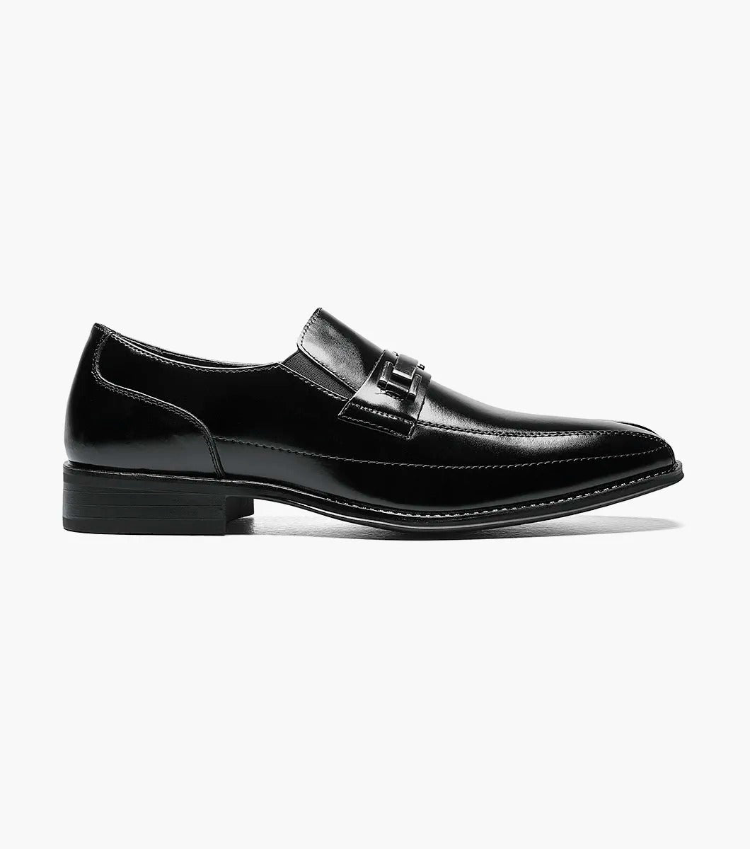 The Stacy Adams WAKEFIELD Bike Toe Bit Slip On in black is a sleekly designed leather men's dress shoe with a metallic decorative strap across the top and a cushioned footbed for added comfort. This perfectly crafted slip-on style offers easy wear.