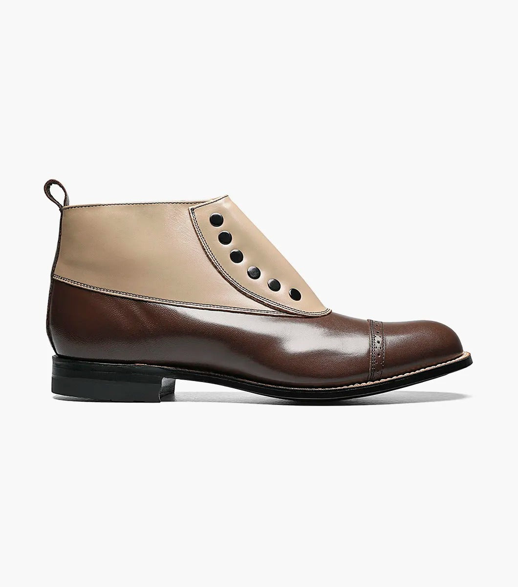 Presenting the Stacy Adams MADISON Spectator Spat Cap Toe Boot in "Brown Multi" (Style 00026-249), from renowned brand STACY ADAMS. This boot features a sophisticated design with a brown kidskin leather toe cap, a tan upper, distinctive black buttons, and is completed with a low heel.