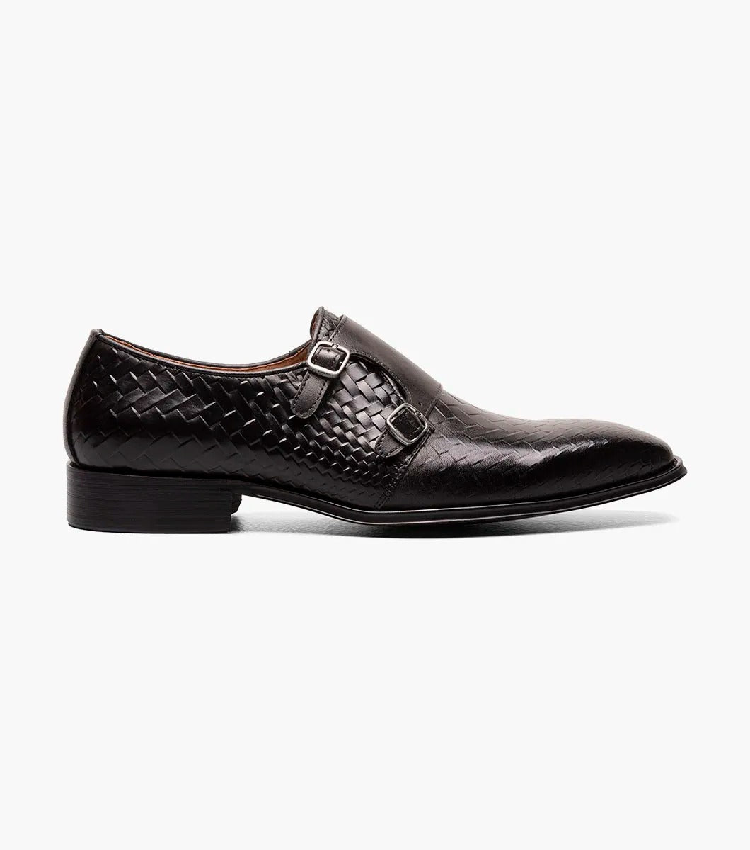 An angled view of the Stacy Adams - TORRANCE Plain Toe Double Monk Strap in Black offers a look at its black woven leather dress design, burnished finish, double monk strap, and low heel.