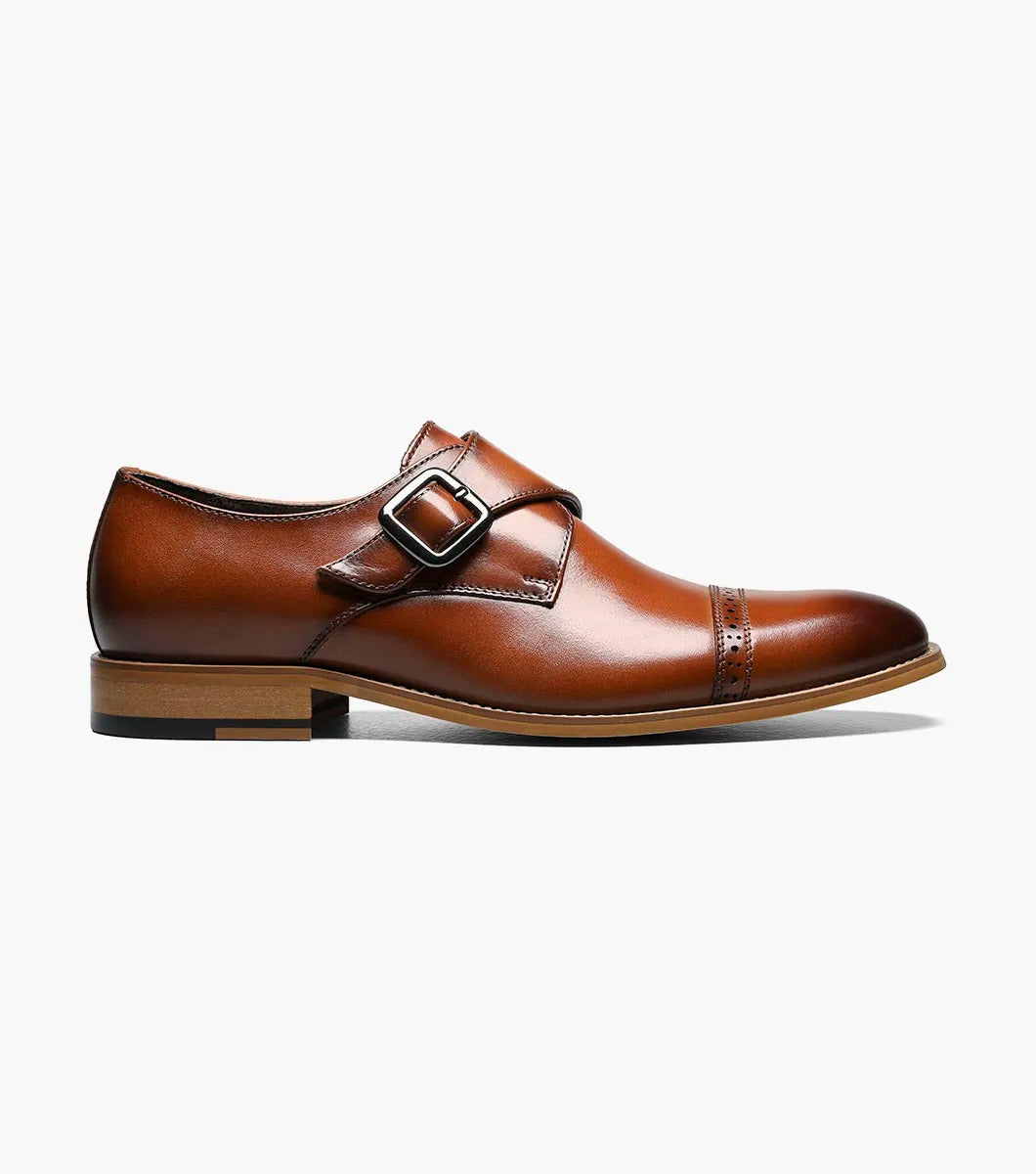 The Stacy Adams DESMOND Cap Toe Monk Strap in cognac combines a buckle, decorative perforations, cap toe detailing, and a wooden heel for a sophisticated look.