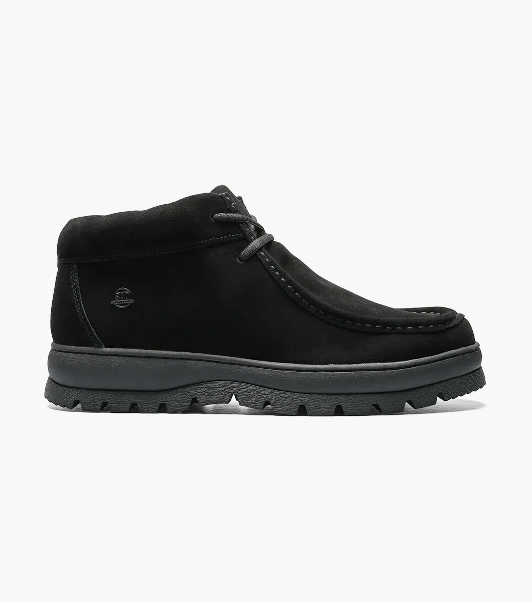 The Stacy Adams - DUBLIN II Moc Toe Boot in black suede, with a thick rubber sole and the signature Moc Toe design, is showcased against a white background.