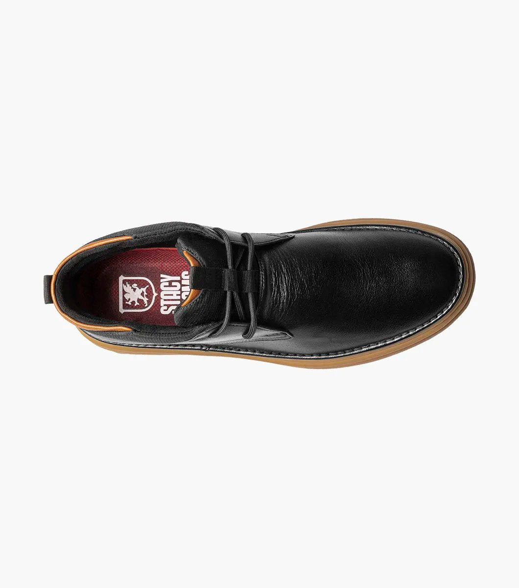 The Stacy Adams DELSON Plain Toe Chukka Boot in black features an ankle-high design with a brown rubber sole, a lace-up closure, and added arch support for comfort.