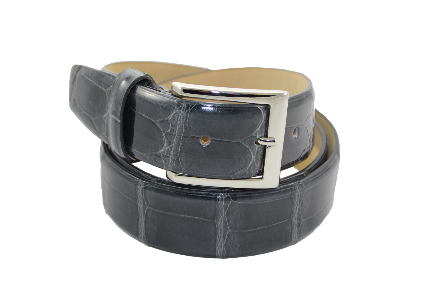 The Fennix Alligator Belt (301) by Fennix of Italy, featuring a sleek silver buckle, is elegantly coiled up and available in various colors to complement any style.