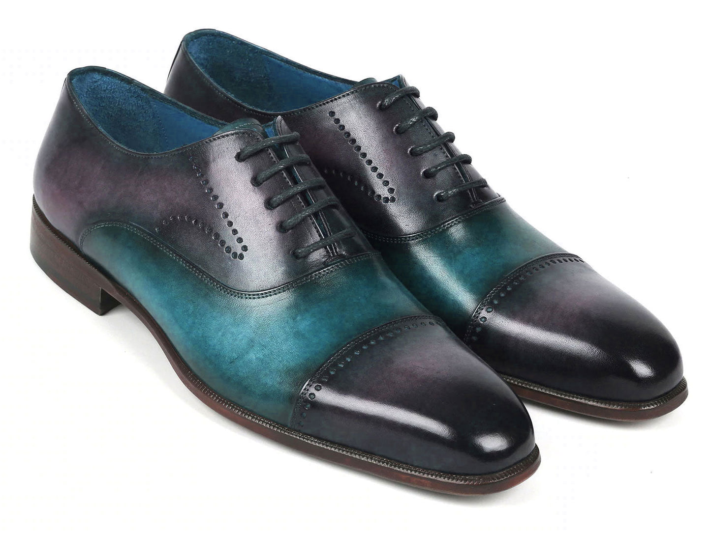 Introducing the Paul Parkman Cap Toe Oxfords in a stunning purple and turquoise combination. Crafted with meticulous attention to detail, these shoes feature hand-painted leather, laces, and decorative perforations that add an elegant touch.