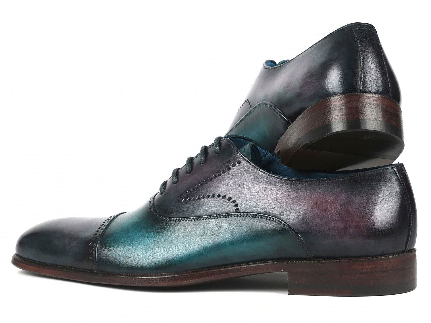 Introducing the Paul Parkman Cap Toe Oxfords in a stunning purple and turquoise combination. Crafted with meticulous attention to detail, these shoes feature hand-painted leather, laces, and decorative perforations that add an elegant touch.