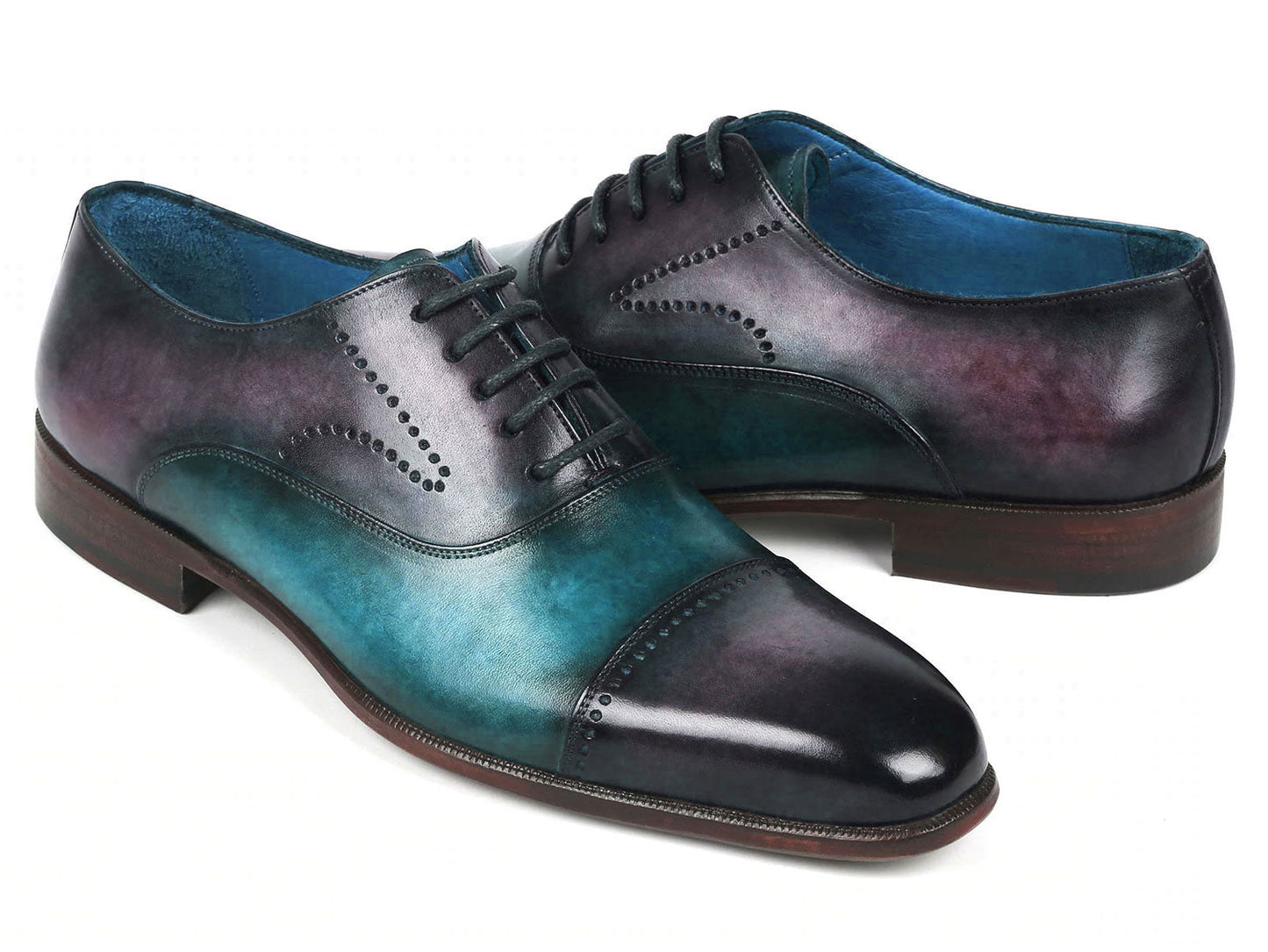 Introducing the Paul Parkman Cap Toe Oxfords in a stunning purple and turquoise combination. Crafted with meticulous attention to detail, these shoes feature hand-painted leather, laces, and decorative perforations that add an elegant touch.