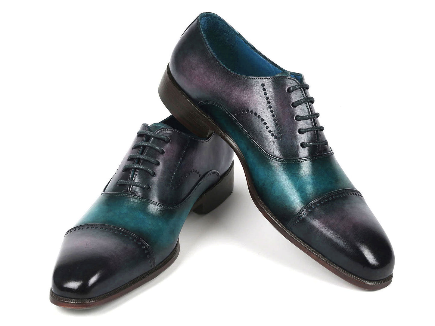 Introducing the Paul Parkman Cap Toe Oxfords in a stunning purple and turquoise combination. Crafted with meticulous attention to detail, these shoes feature hand-painted leather, laces, and decorative perforations that add an elegant touch.