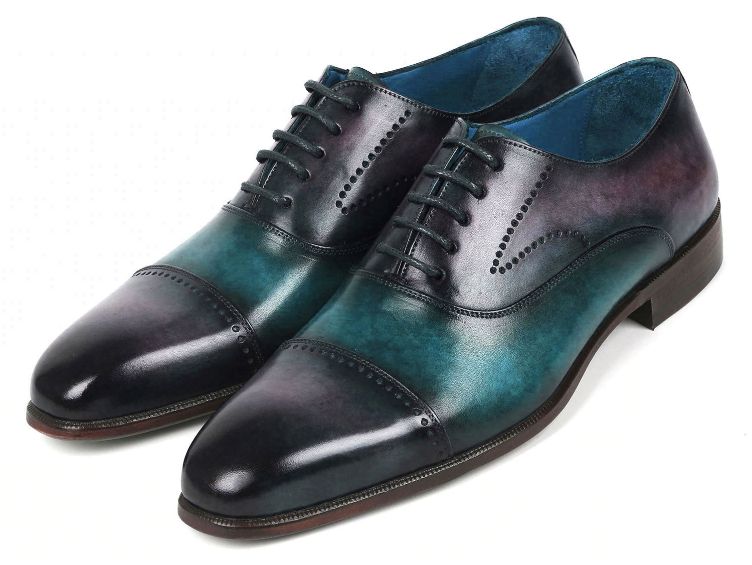 Introducing the Paul Parkman Cap Toe Oxfords in a stunning purple and turquoise combination. Crafted with meticulous attention to detail, these shoes feature hand-painted leather, laces, and decorative perforations that add an elegant touch.