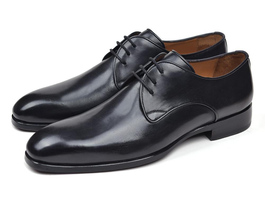 A pair of Paul Parkman Black Leather Derby Shoes - 34DR-BLK in Italian calfskin, featuring classic lace-up styling, with one shoe upright and the other on its side to display the sole.