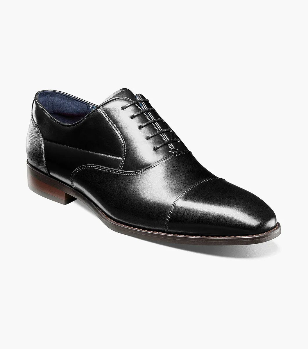 A side view of the Stacy Adams - KALLUM Cap Toe Oxford in black leather, featuring a burnished finish and a dark brown sole.