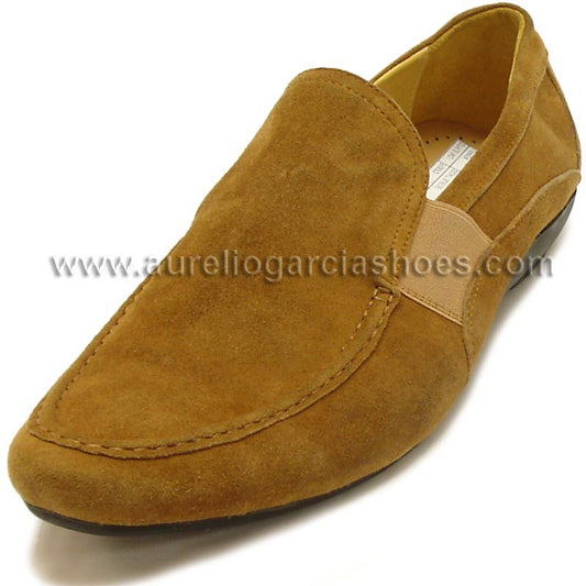 The FI-3072 Brown Encore by Fiesso is a stylish brown suede loafer featuring a rubber sole and elastic band detail, combining fashion and comfort. Displayed at an angle, its cushioned insole enhances the ease of this sleek slip-on from Fiesso.