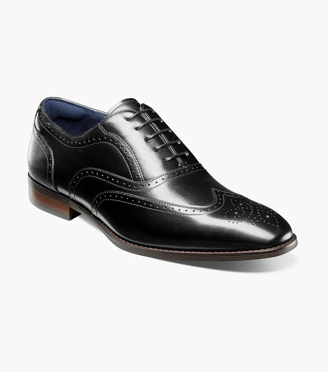 Presenting the Stacy Adams - KAINE Wingtip Oxford in Black, style number 25569-001, from STACY ADAMS. This shoe boasts a classic wingtip design with decorative perforations and laces, featuring a low heel and sleek profile. It is crafted for comfort with anatomical arch support.