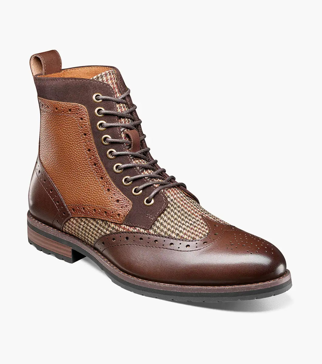 Introducing the Stacy Adams OSWYN Wingtip Lace Up Boot in Brown Multi. This stylish boot from STACY ADAMS features a combination of brown leather and tweed with intricate perforations, a mixed material upper, and a textured sole for unmatched comfort. Enhanced with a Memory Foam insole, these lace-ups provide superior cushioning and support for all-day wear. Product code: 25552-249.