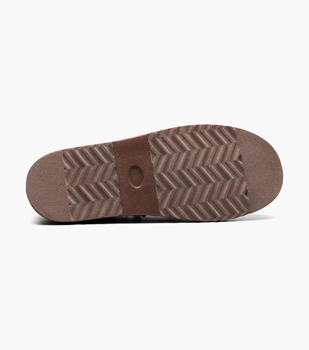 The Stacy Adams - COZE Moc Toe Slip On - Tan Multi - 25558-238, from STACY ADAMS, boasts a textured fabric exterior and soft faux shearling lining. It features a cushioned insole and a brown rubber sole.