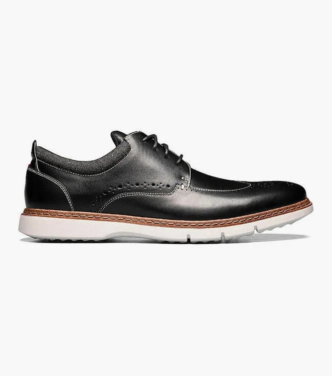 Stacy Adams' SYNERGY Wingtip Oxford in black (25418-001) showcases decorative perforations and a lace-up design, complemented by a contrasting light brown sole and featuring the RedZone footbed for enhanced comfort.